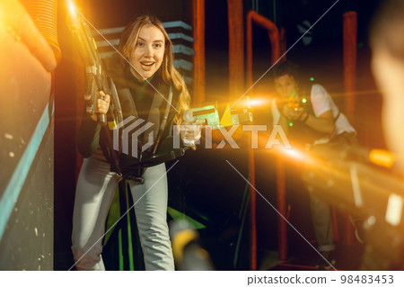 Young woman playing lasertag in arena Young woman playing lasertag in arena 98483453