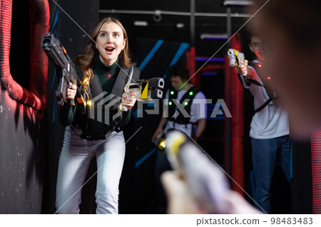 Young lady having fun playing lasertag in arena 98483483