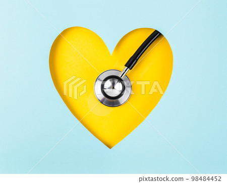 A Healthcare Stethoscope Medical on Yellow Background with Paper Heart Shape. 98484452