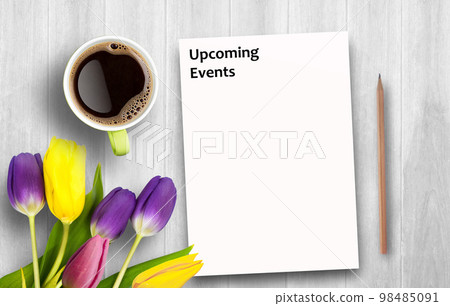 Text with Upcoming Events and coffee cup, notebook,pencil on white wooden table. 98485091