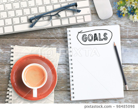 Top view with goals on notebook,keyboard,coffee and glasses on wood table 98485098