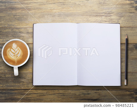 Office desk with blank notebook and coffee on wood table background. 98485221