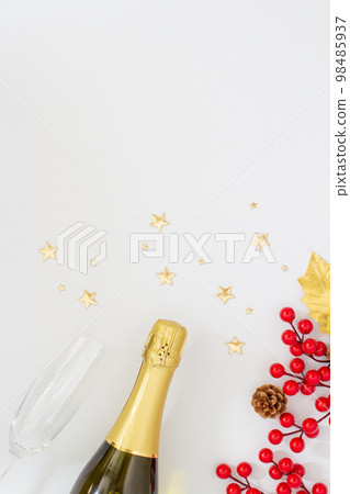 Christmas party concept, Champagne with glass and christmas decoration with holly berries and stars Christmas party concept, Champagne with glass and christmas decoration with holly berries and stars 98485937