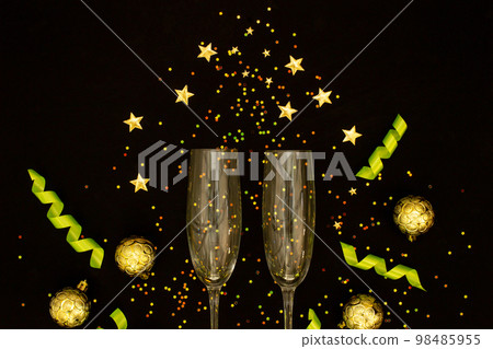 Champagne with party concept, Champagne glass with ribbon and gold ball with confetti colorful star 98485955