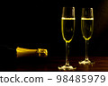 Festive party concept, Glass of champagne with champagne bottle on wood table over black background 98485979