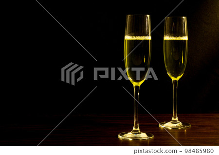 Champagne with party concept, Glass of champagne on wooden table over black background 98485980