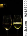 Champagne with party concept, Pour champagne from bottle into glass on black background 98485990