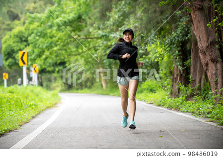 Healthy woman jogging run and workout on road outdoor 98486019