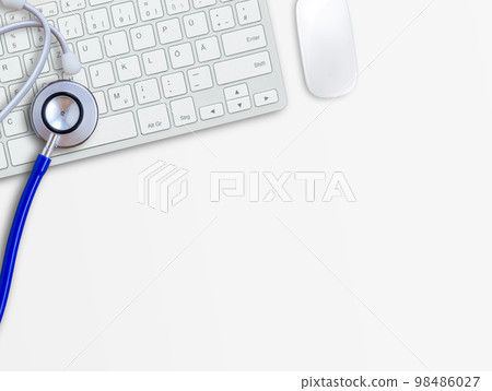 Keyboard with blue stethoscope on white table background.Computer servise and repair concept 98486027