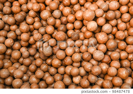 macadamia nuts texture background, fresh natural shelled raw macadamia nuts in a full frame, close up pile of roasted macadamia nut - top view macadamia nuts texture background, fresh natural shelled raw macadamia nuts in a full frame, close up pile of roasted macadamia nut - top view 98487478