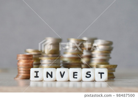 invest and a coin on wooden table background, invest business economy concept of money and finance investments 98487500