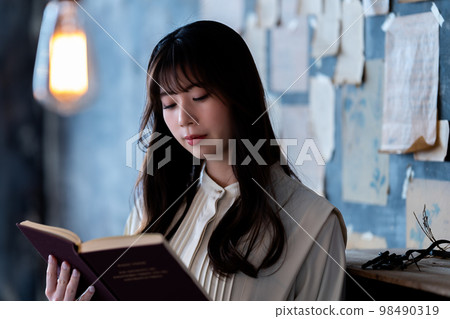 Young woman reading in a chic room Young woman reading in a chic room 98490319