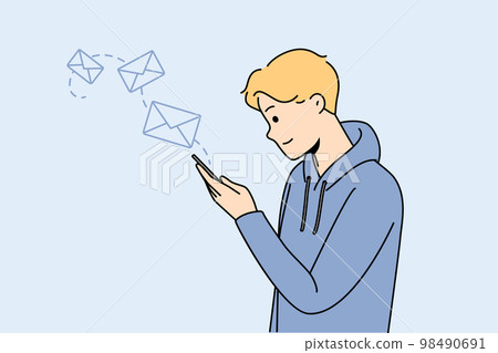 Happy man texting online on cellphone Happy man texting online on cellphone 98490691
