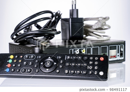 TV set-top box prepared for installation, digital TV kit on white background close-up with reflection TV set-top box prepared for installation, digital TV kit on white background close-up with reflection 98491117