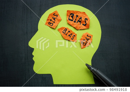 Paper in the shape of a head and sheets with the inscription bias. 98491918
