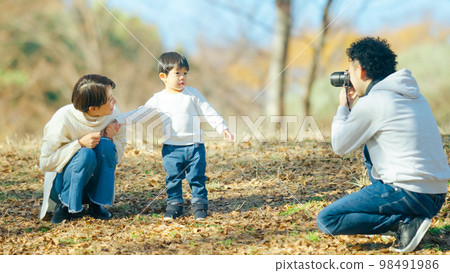 A father photographing his two-year-old son A father photographing his two-year-old son 98491986