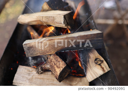 Bonfire flame and burning logs close-up. Bonfire flame and burning logs close-up. 98492091