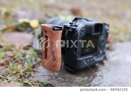 Photo camera with side handle outdoors close-up. 98492105