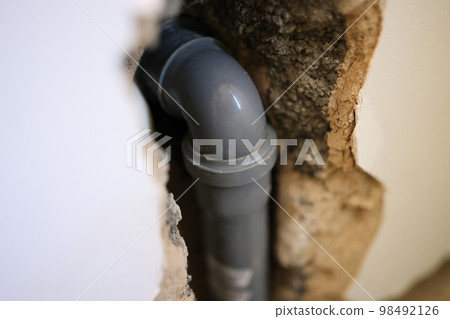 PVC pipe in wall of house close up. 98492126