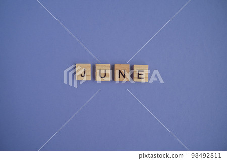 The sixth month of the year June - from isolated letters on wooden blocks in natural color, in high resolution. Very Peri Color of the Year background, copy space. Flat lay, step by step, step 6. 98492811