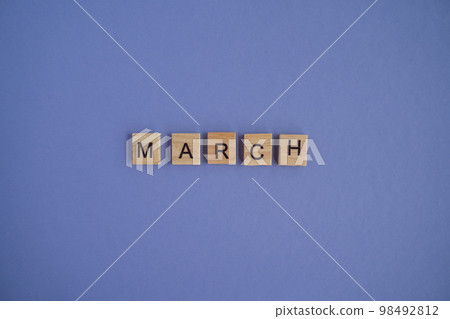 The third month of the year MARCH - from isolated letters on wooden blocks in natural color, in high resolution. Very Peri Color of the Year background, copy space. Flat lay, step by step, step 3. 98492812