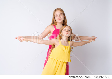 Two beautiful smiling hipster girls in trendy summer hipster clothes. Carefree 98492922