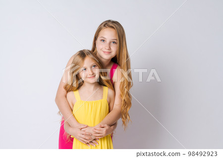 Teenagers and friendship concept happy smiling cute girls sisters teenagers 98492923