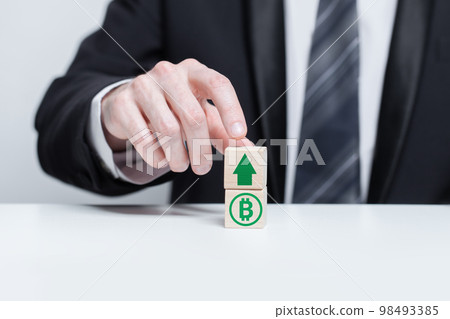 Wooden blocks with green currency bitcoin icon and green arrow up. Growth and depreciation concept. 98493385