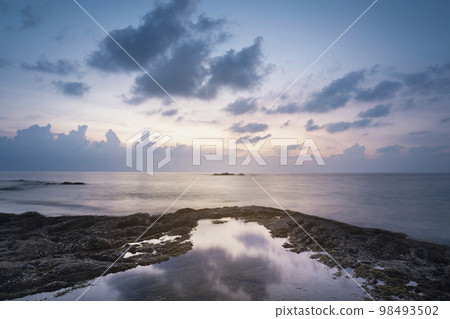 evening sunset on the sea. reflection of the sea in the water and coastal rocks, nang thong beach khao lak phuket thailand. 98493502