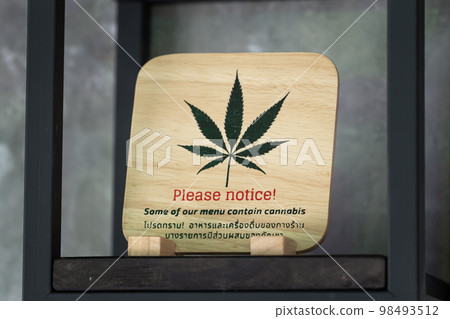 A sign saying that some dishes on the menu contain cannabis, in a cafe in Thailand, where marijuana is legalized. A sign saying that some dishes on the menu contain cannabis, in a cafe in Thailand, where marijuana is legalized. 98493512