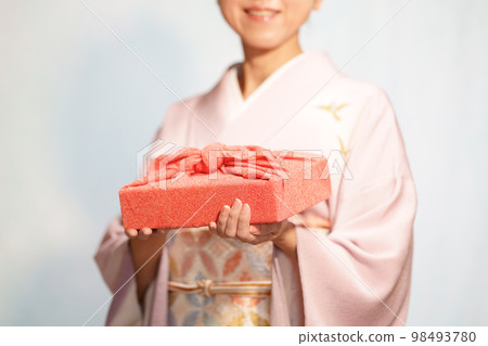 A woman in a kimono with a furoshiki wrapping faceless A woman in a kimono with a furoshiki wrapping faceless 98493780