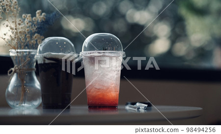 Drinks in clear plastic glasses Placed on the table in the cafe Drinks in clear plastic glasses Placed on the table in the cafe 98494256