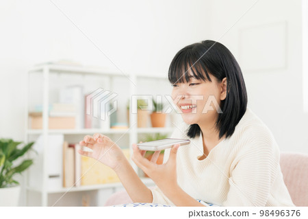 Asian teenager voice assistant with smartphone. Asian teenager voice assistant with smartphone. 98496376