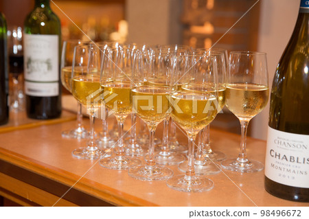 white wine poured into a wine glass 98496672