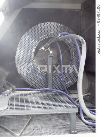 Inside Shot blasting machine. Open machine for Shot blasting of objects. Industrial machine Inside Shot blasting machine. Open machine for Shot blasting of objects. Industrial machine 98497100