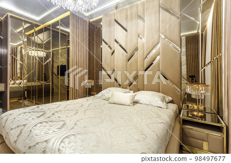 Luxury bedroom interior with parquet and mirror walls Luxury bedroom interior with parquet and mirror walls 98497677