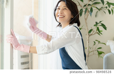 middle woman cleaning windows 98498528