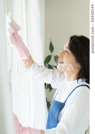 middle woman cleaning windows 98498544