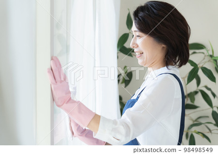 middle woman cleaning windows 98498549