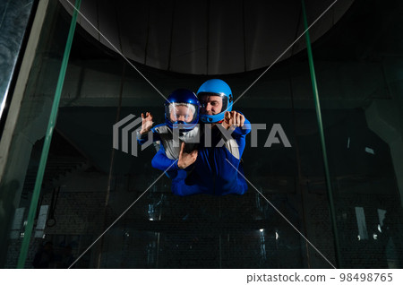 A man teaches a boy to fly in a wind tunnel. Lack of gravity. A man teaches a boy to fly in a wind tunnel. Lack of gravity. 98498765