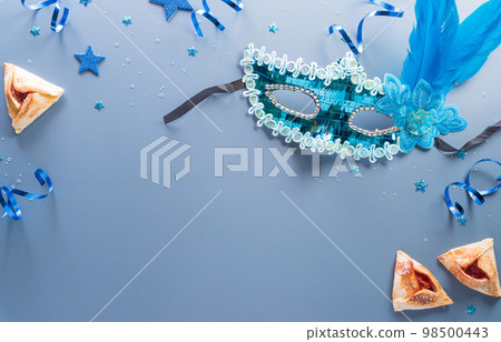 Happy Purim carnival decoration concept made from mask and sparkle star and hamantaschen cookies on pastel background. (Happy Purim in Hebrew, jewish holiday celebrate) Happy Purim carnival decoration concept made from mask and sparkle star and hamantaschen cookies on pastel background. (Happy Purim in Hebrew, jewish holiday celebrate) 98500443
