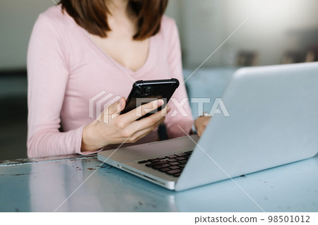 businesswoman hand using smart phone, tablet payments and holding credit card online shopping, omni channel, digital tablet docking keyboard computer at office in sun light.. businesswoman hand using smart phone, tablet payments and holding credit card online shopping, omni channel, digital tablet docking keyboard computer at office in sun light.. 98501012