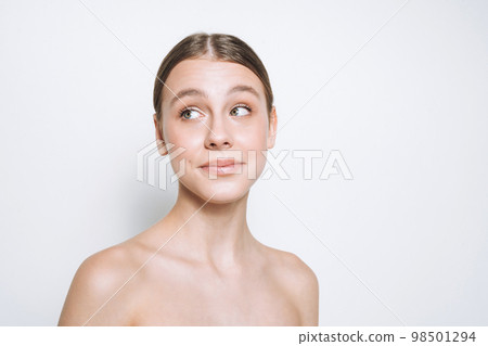 Beauty portrait of cute young girl with fresh skin tone looking away on white background isolated Beauty portrait of cute young girl with fresh skin tone looking away on white background isolated 98501294