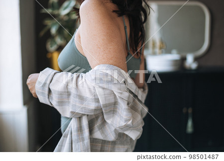 Crop photo of self loving plus size middle aged woman in underwear in bathroom at home 98501487