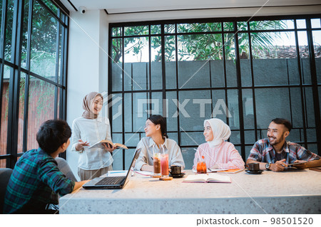 a girl wearing a headscarf explains the problem a girl wearing a headscarf explains the problem 98501520
