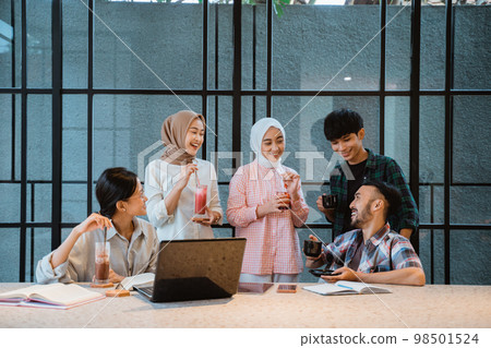 a group of young asian people enjoying chatting a group of young asian people enjoying chatting 98501524