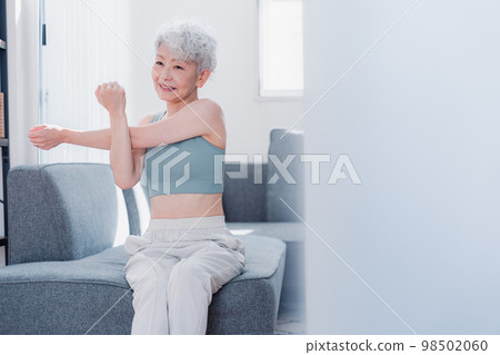 Senior woman training at home Senior woman training at home 98502060