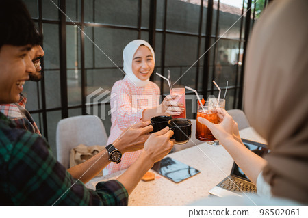 some people bring various drinks with glasses of toast 98502061