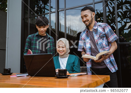 group of college students gathered to do their course work group of college students gathered to do their course work 98502077