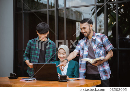 two male college students and a female student group work 98502095